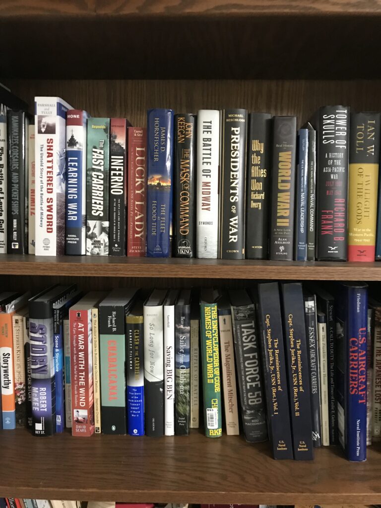 Two of my book shelves showing some of the books I am using to research my book on USS Franklin.