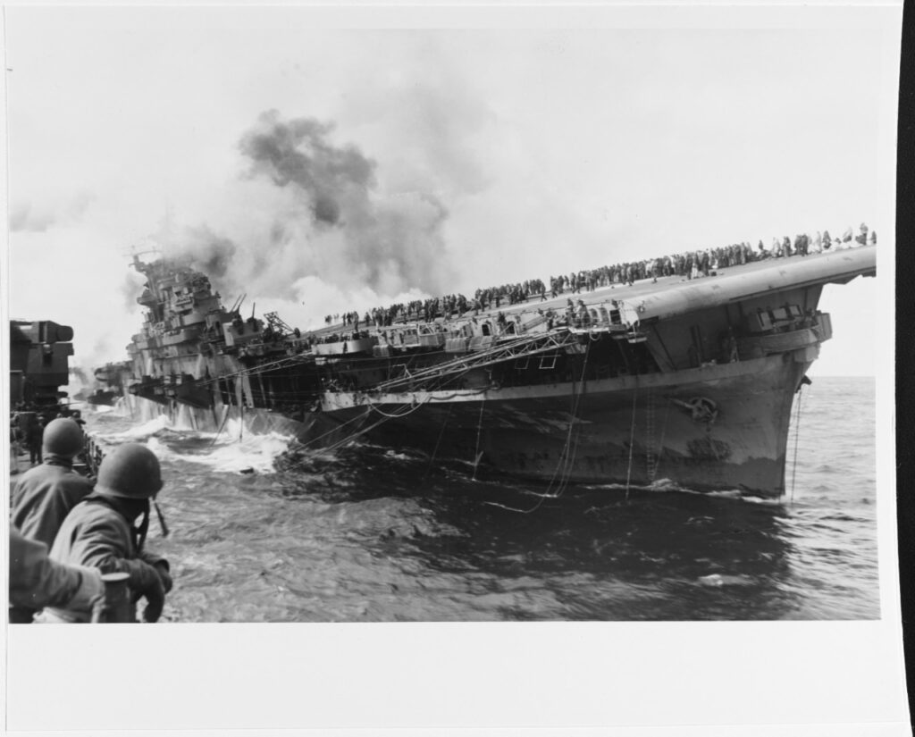 USS Franklin Listing to one side after being attacked on March 19, 1945 as seen from USS Santa Fe