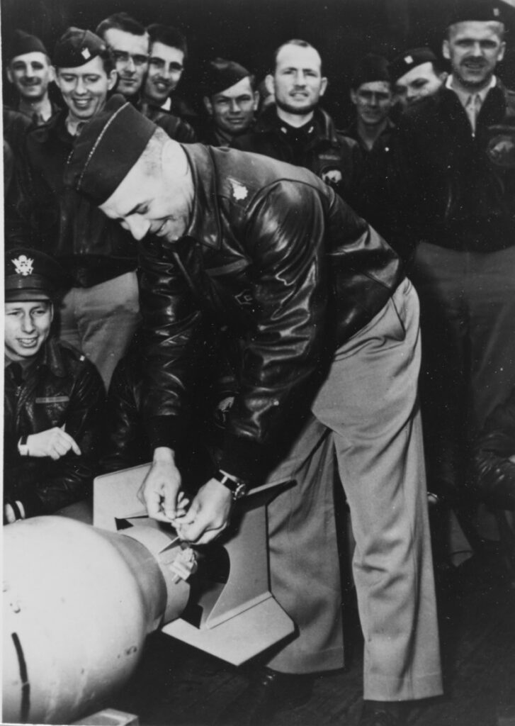 NH-102457. Lieutenant Colonel James H. Doolittle attaches a Japanese medal to a bomb. Photographed on board Hornet shortly before the Doolittle Raid "B-25s took off.