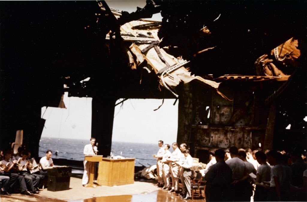 USS Franklin (CV-13) Church service on the ship's ruined hangar deck, taken upon her return to the U.S. from the Pacific for repair of battle damage received off Japan on 19 March 1945. The location is probably in, or near, New York Harbor, circa 28 April 1945. Official U.S. Navy Photograph, now in the collections of the National Archives. 80-G-K-5056