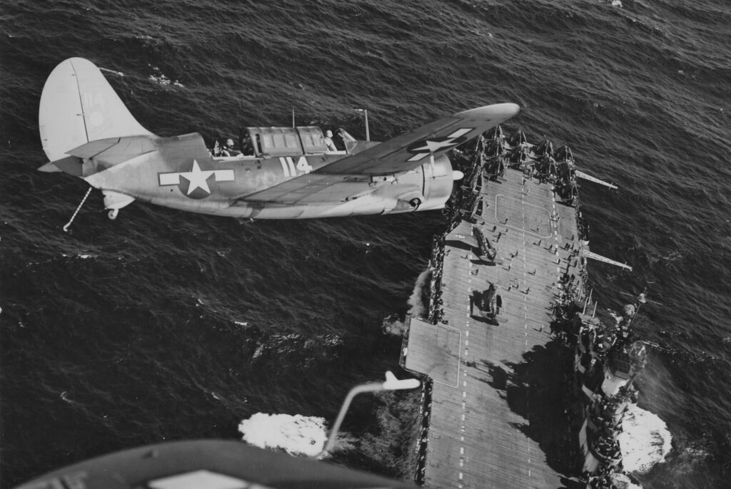 Curtiss SB2C-3 of CV-12 prepare to land on the carrier Hornet following strikes on Japanese shipping in the South China Sea in mid-January 1945. (Naval History and Heritage Command)