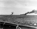 Two carriers burning after separate kamikaze strikes. USS Franklin (CV-13), at right, and USS Belleau Wood (CVL-24) afire after being hit by Japanese kamikaze suicide planes, while operating off the Philippines on 30 October 1944. Photographed from USS Brush (DD-745). US Navy 80-G-326798