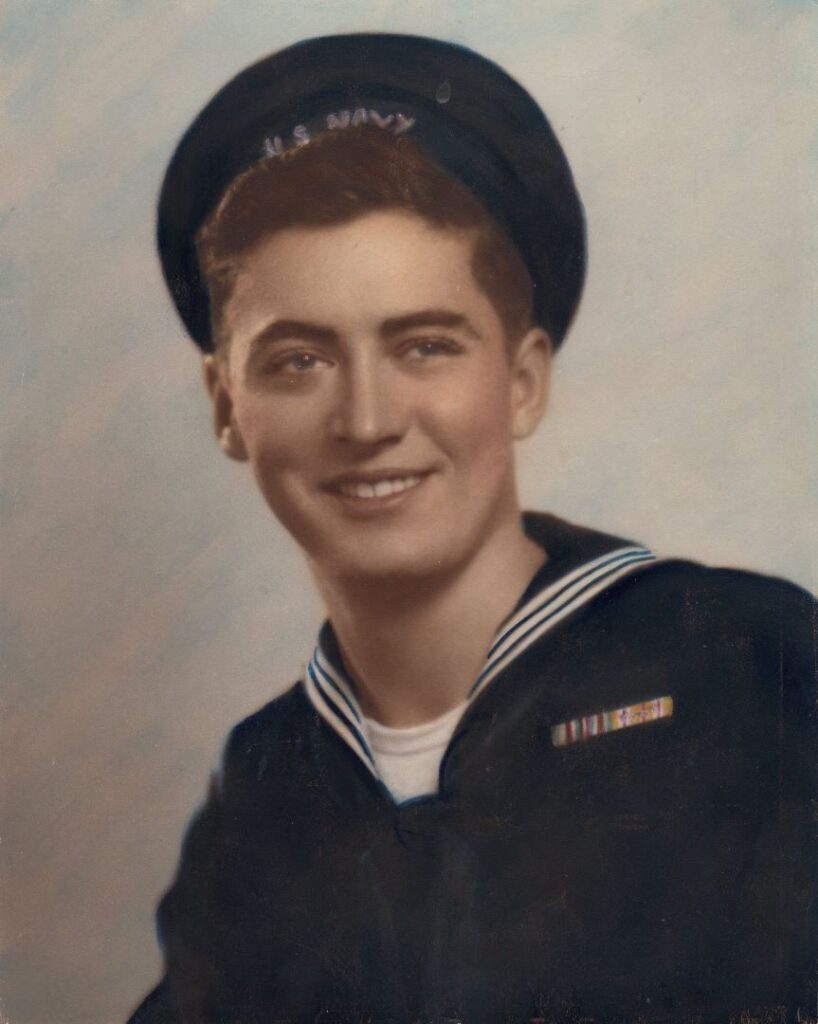 A smiling Seaman 2nd class Elden Rogers is shown wearing a blue navy uniform and cover in a photo taken in December 1944. He would be reported missing on 19 March 1945 on his 19th birthday.