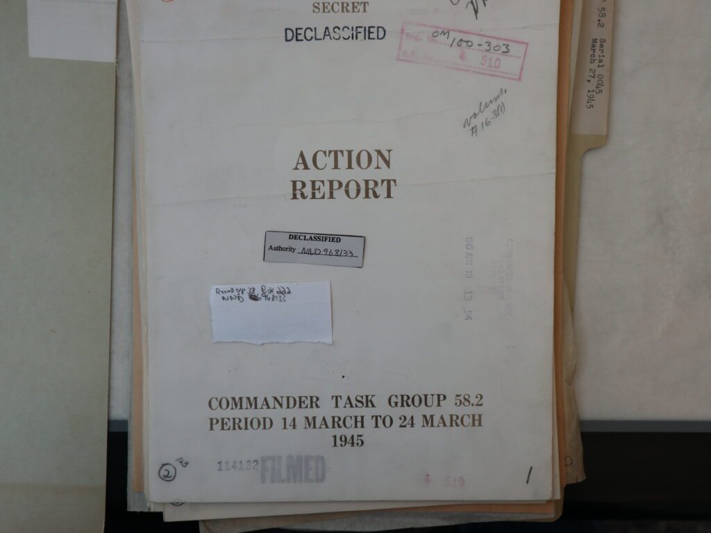 Title Page for a report named, "Action Report Commander Task Group 58.2 Period 14 March to 24 March 1945." The page has been rubber stamped several times. One showing the report, formerly classified, secret, has been declassified. Another gives what appears to be a filing code.