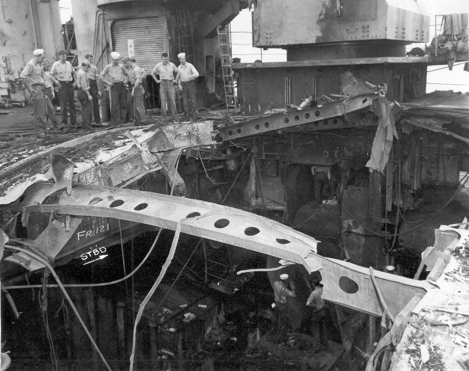 USS Franklin Sailors examine damage to the flight and hangar decks after the 30 October 1944 Kamikaze attack.