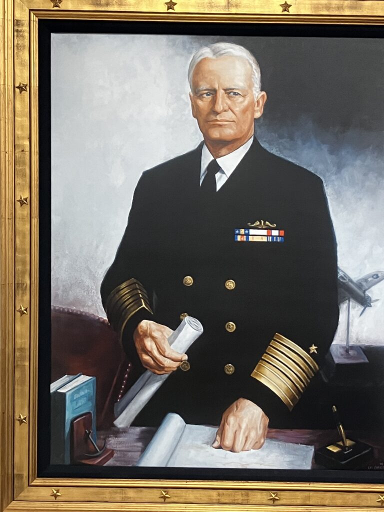 Official painting of Admiral Chester Nimitz. Done in oil, it shows him standing at a desk in his uniform holdin a rolled up document in his right hand with his left fist resting on either a map or other document. This portrait hangs on the second floor of the Museum of the Pacific War. (Author's photo)