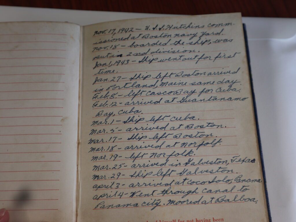 The open diary shows a blank page on the left. The right page contains the first entries dated Nov 17, 1942 mentions USS Hutchins being commssioned in the Boston Naval Yard.