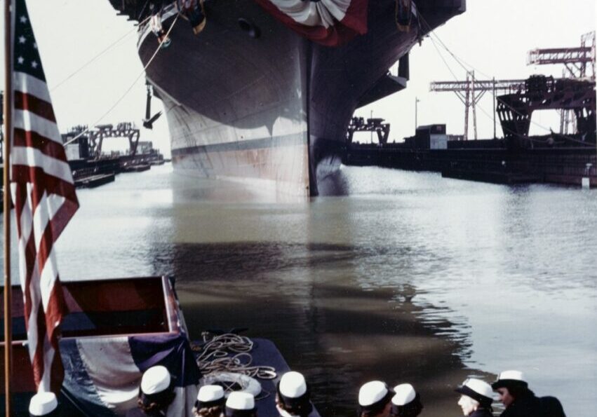 The ship is floated out of her building dock immediately after christening, at the Newport News Shipbuilding and Drydock Company shipyard, Newport News, Virginia, on 14 October 1943. Note WAVES officers in the foreground. The WAVES' Director, Lieutenant Commander Mildred H. McAfee, USNR, was Franklin's sponsor. Official U.S. Navy Photograph, now in the collections of the National Archives.