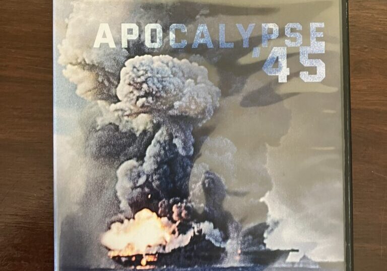 The DVD Cover of Apocalypse '45 showing USS Franklin wracked by tremendous explosions and towering clouds of smoke and flame