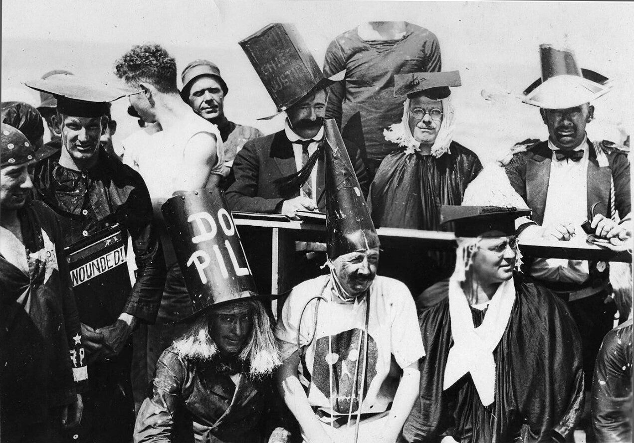 Men dressed in odd clothing preparing to participate in the Crossing of the Line Ceremony