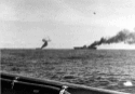 Two carriers burning after separate kamikaze strikes. USS Franklin (CV-13), at right, and USS Belleau Wood (CVL-24) afire after being hit by Japanese kamikaze suicide planes, while operating off the Philippines on 30 October 1944. Photographed from USS Brush (DD-745). US Navy 80-G-326798
